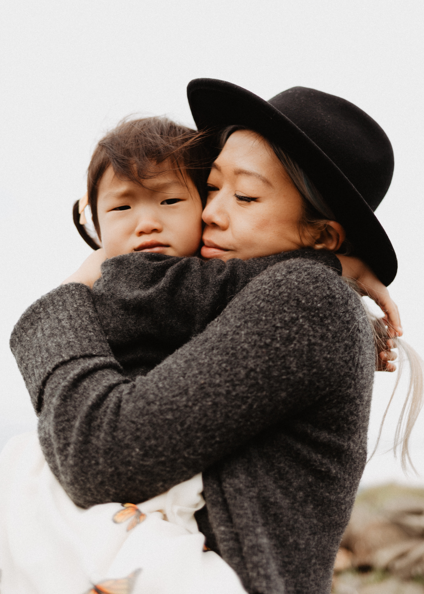 Outdoor family portrait of a mother holding her young child